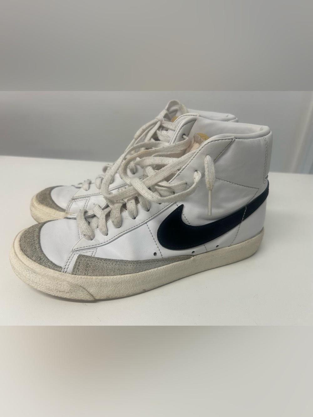Nike White High-Top Sneakers with Black Swoosh